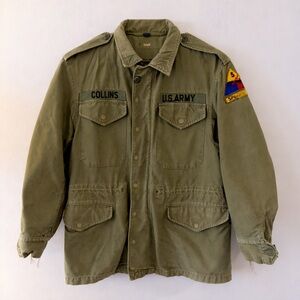 Authentic vintage U.S. Army M-65 field jacket in OG-107 olive green.